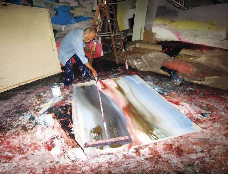 Ed Clark in his studio using his push broom